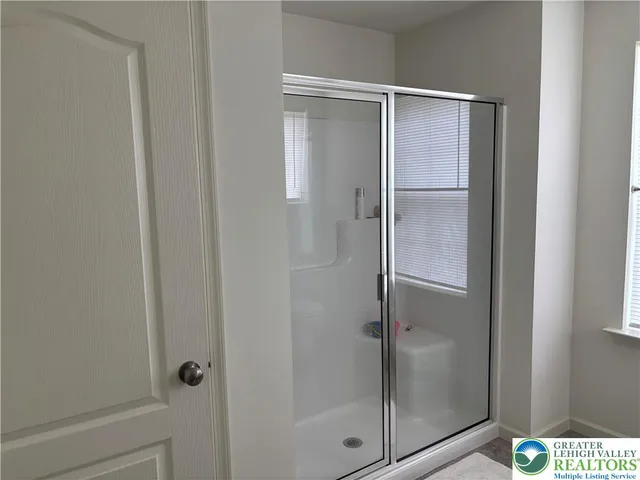 a bathroom with a glass shower door