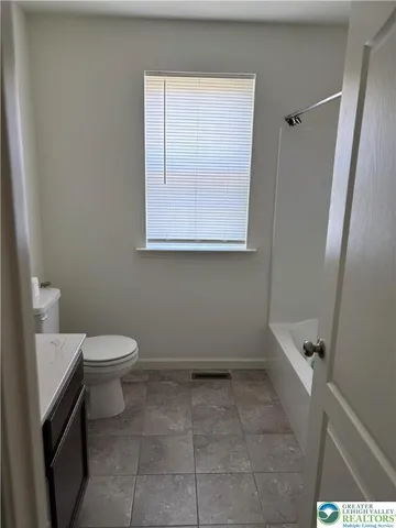 a bathroom with a toilet a sink and a bath tub