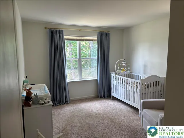 a view of a bedroom with furniture and a window