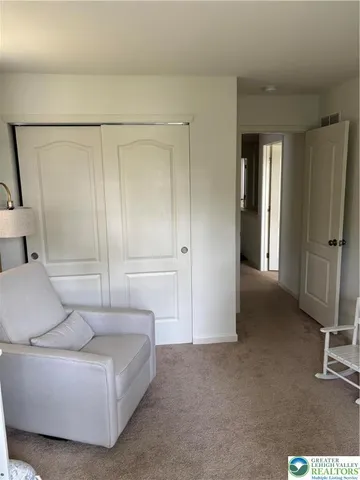 a living room with furniture and a ceiling fan
