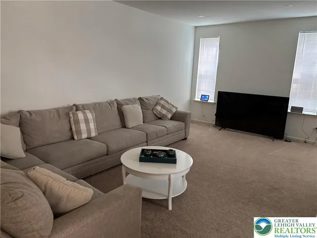 a living room with furniture a fireplace and a window