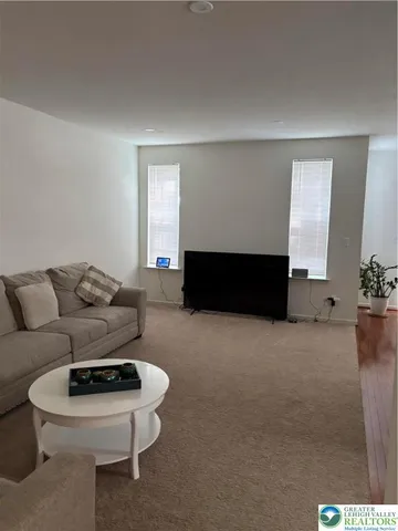 a living room with furniture a window and a fireplace