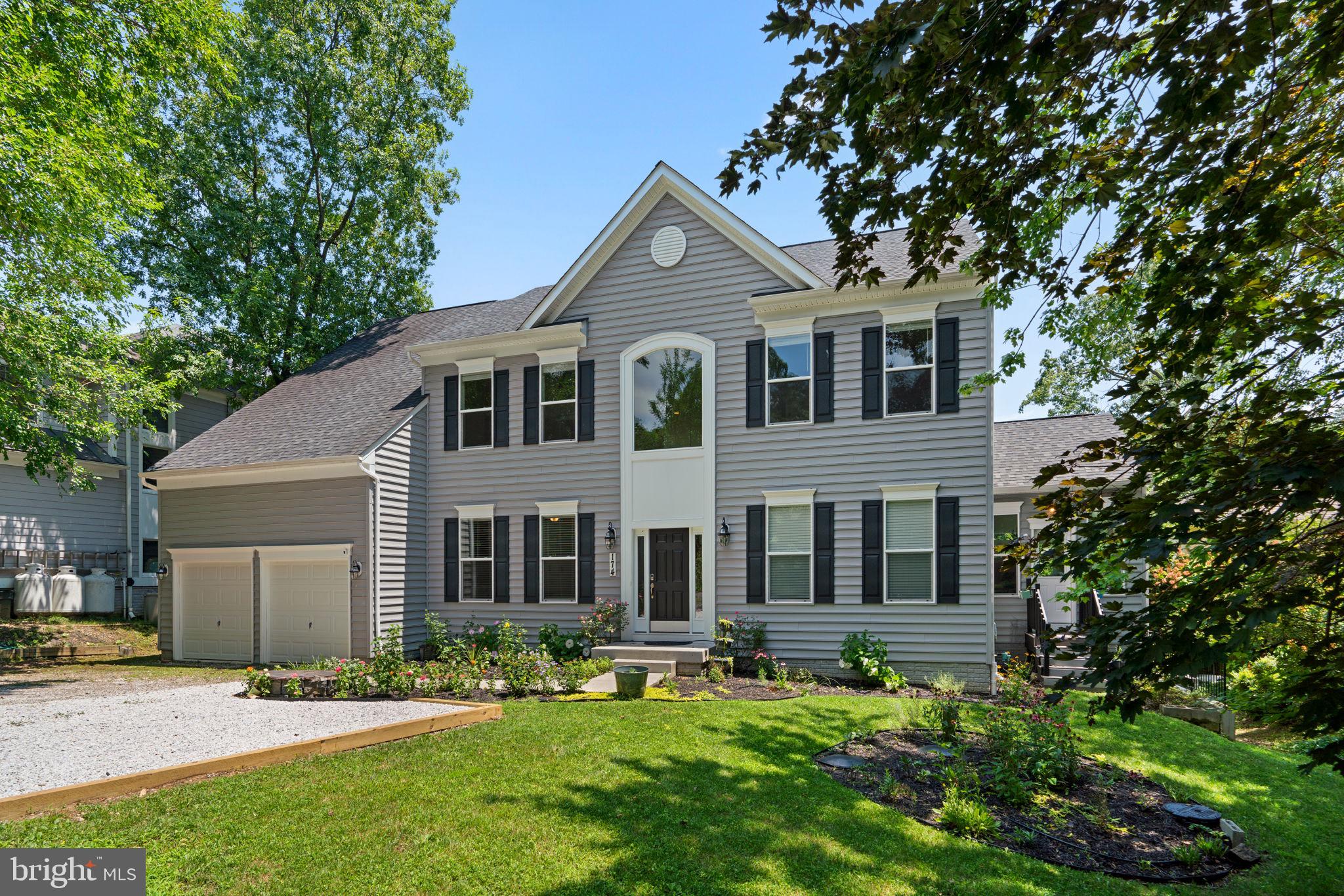 a front view of a house with a yard and porch