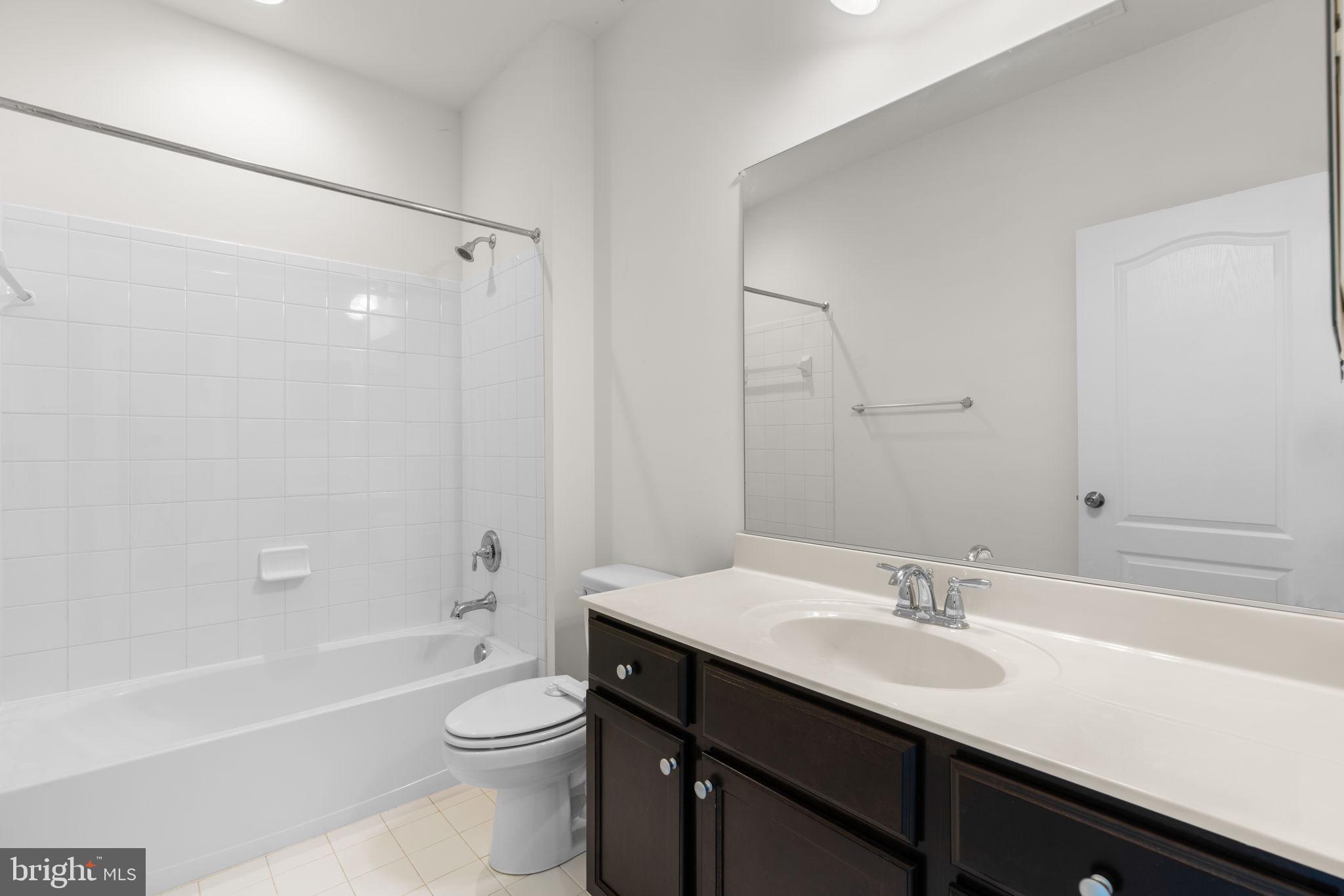 174 Acton Road Annapolis, MD 21403 - Photo 15 of 36 a bathroom with a bathtub shower sink vanity mirror and toilet