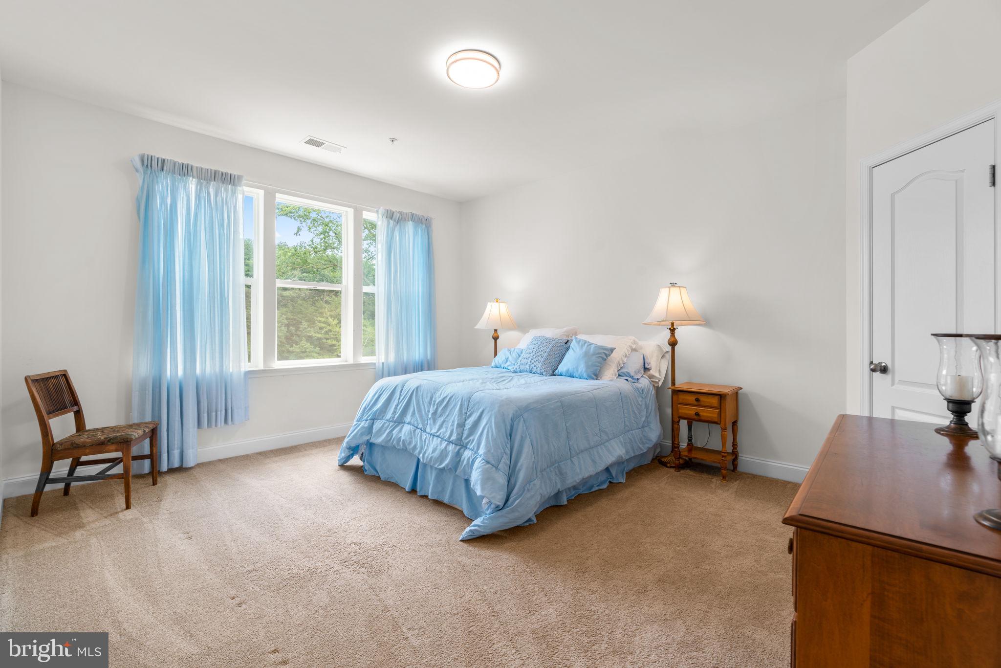 174 Acton Road Annapolis, MD 21403 - Photo 16 of 36 a bed room with a bed and a chair