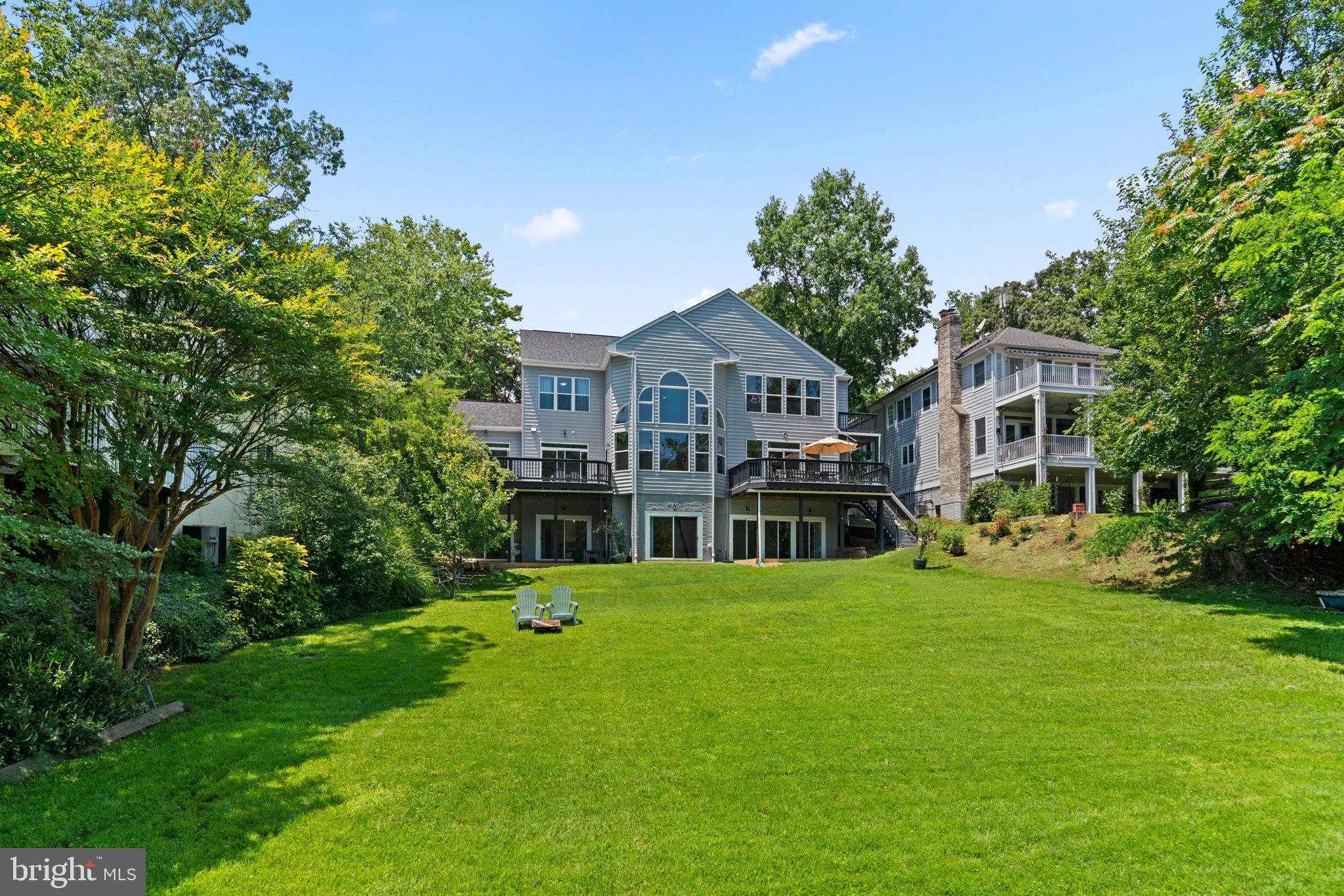 174 Acton Road Annapolis, MD 21403 - Photo 34 of 36 a view of a house with a big yard and potted plants and large trees