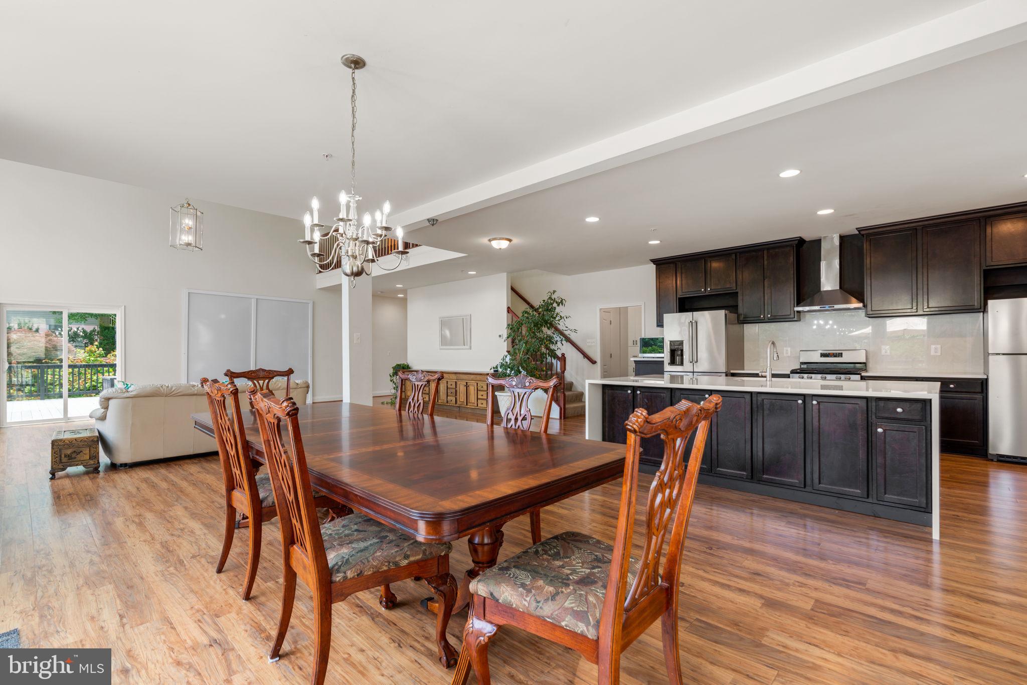 174 Acton Road Annapolis, MD 21403 - Photo 10 of 36 a dining room filled chandelier and wooden floor