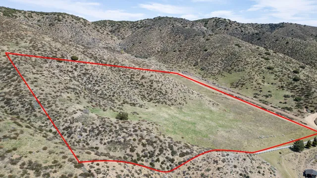 a view of a dry yard with a mountain view