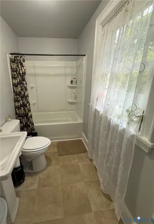 a bathroom with a toilet and shower