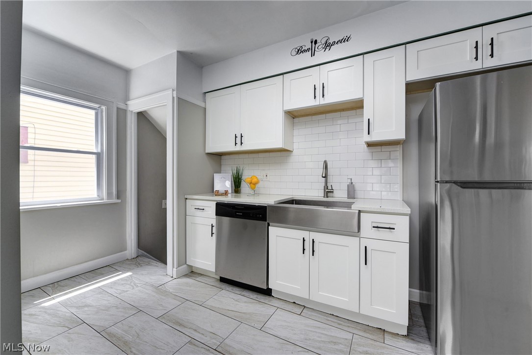 2115 Marlindale Road Cleveland Heights, OH 44118 - Photo 2 of 19 Kitchen featuring light tile patterned flooring, stainless steel appliances, sink, and white cabinets