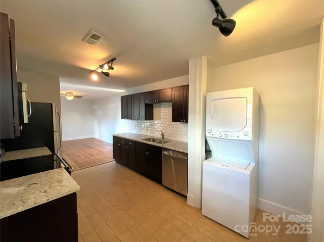 a large kitchen with a stove and a refrigerator