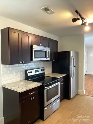 a kitchen with a refrigerator sink and microwave