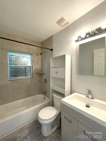 a bathroom with a sink toilet a mirror and shower