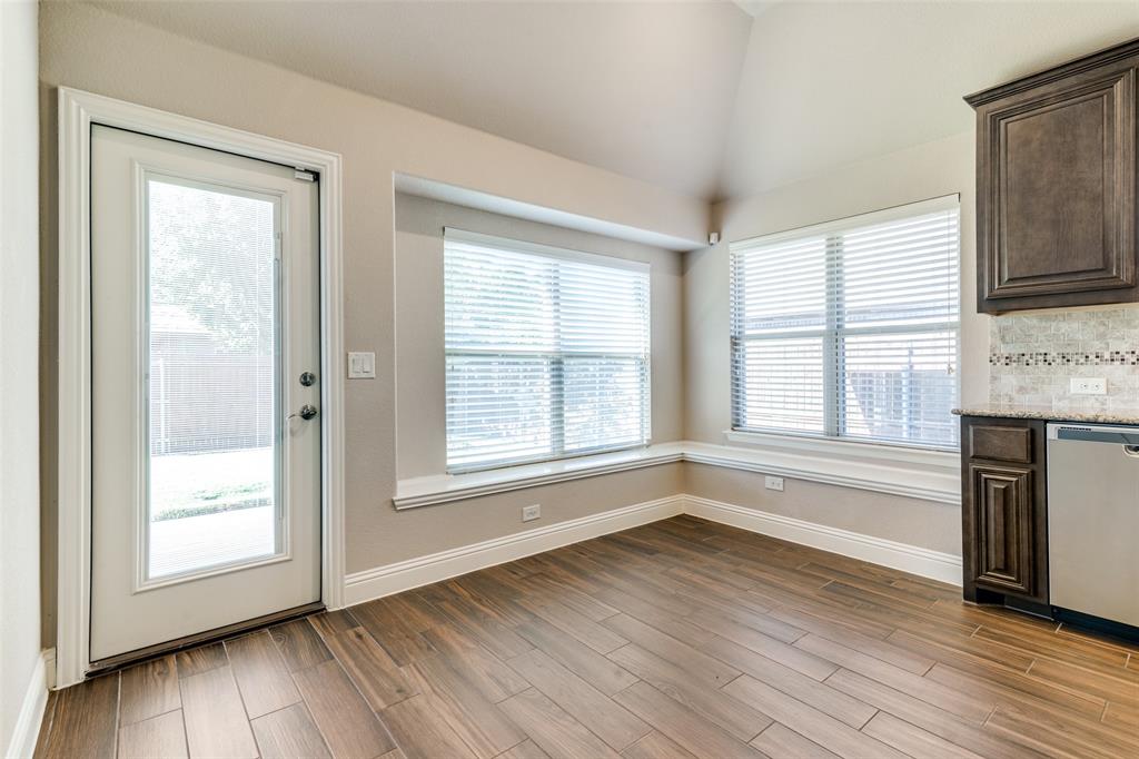 556 Avery Pointe Lavon, TX 75166 - Photo 11 of 32 an empty room with wooden floor and windows