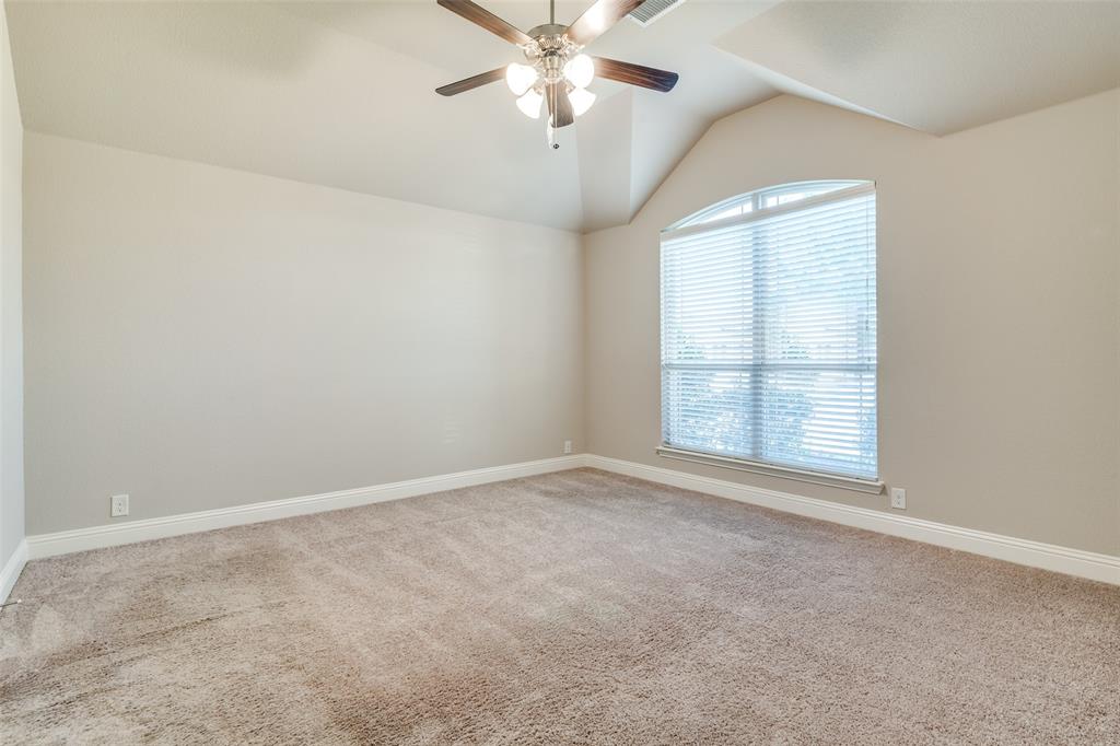 556 Avery Pointe Lavon, TX 75166 - Photo 13 of 32 an empty room with chandelier fan and windows