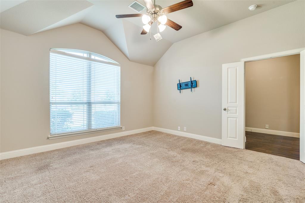 556 Avery Pointe Lavon, TX 75166 - Photo 14 of 32 an empty room with fan and windows