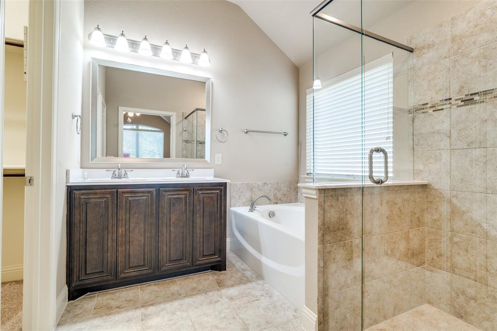 556 Avery Pointe Lavon, TX 75166 - Photo 17 of 32 a bathroom with a tub sink and mirror