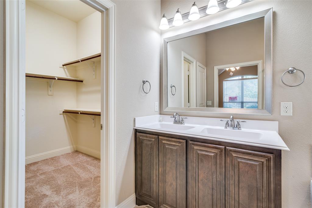556 Avery Pointe Lavon, TX 75166 - Photo 18 of 32 a bathroom with a sink and a mirror