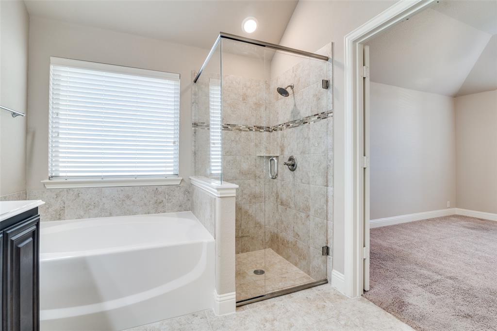 556 Avery Pointe Lavon, TX 75166 - Photo 19 of 32 a bathroom with a bathtub and shower