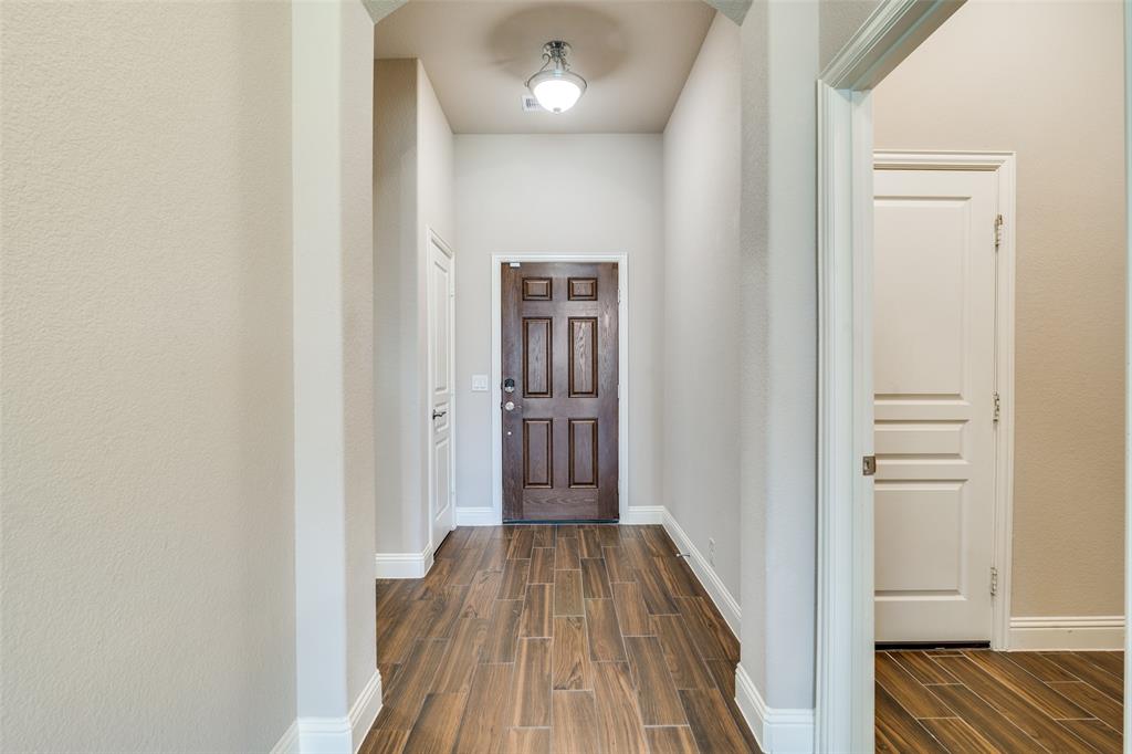 556 Avery Pointe Lavon, TX 75166 - Photo 2 of 32 a view of a hallway with wooden floor and entryway