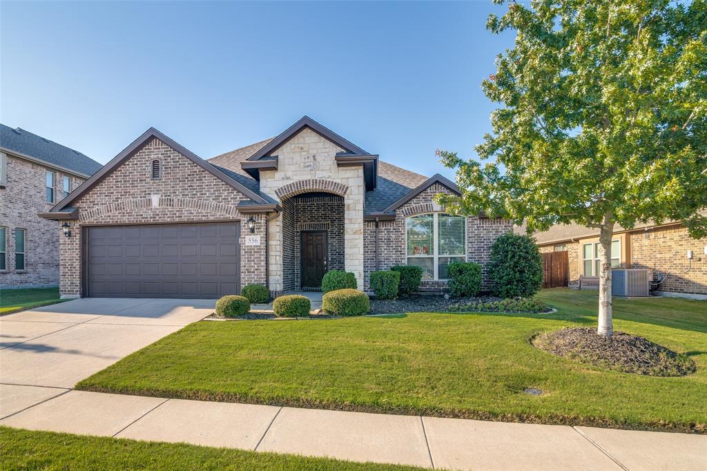 556 Avery Pointe Lavon, TX 75166 - Photo 29 of 32 a front view of a house with a yard and garage