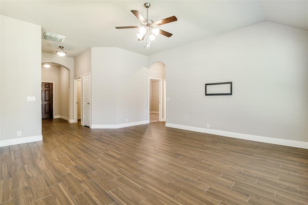 556 Avery Pointe Lavon, TX 75166 - Photo 6 of 32 a view of an empty room with window and wooden floor