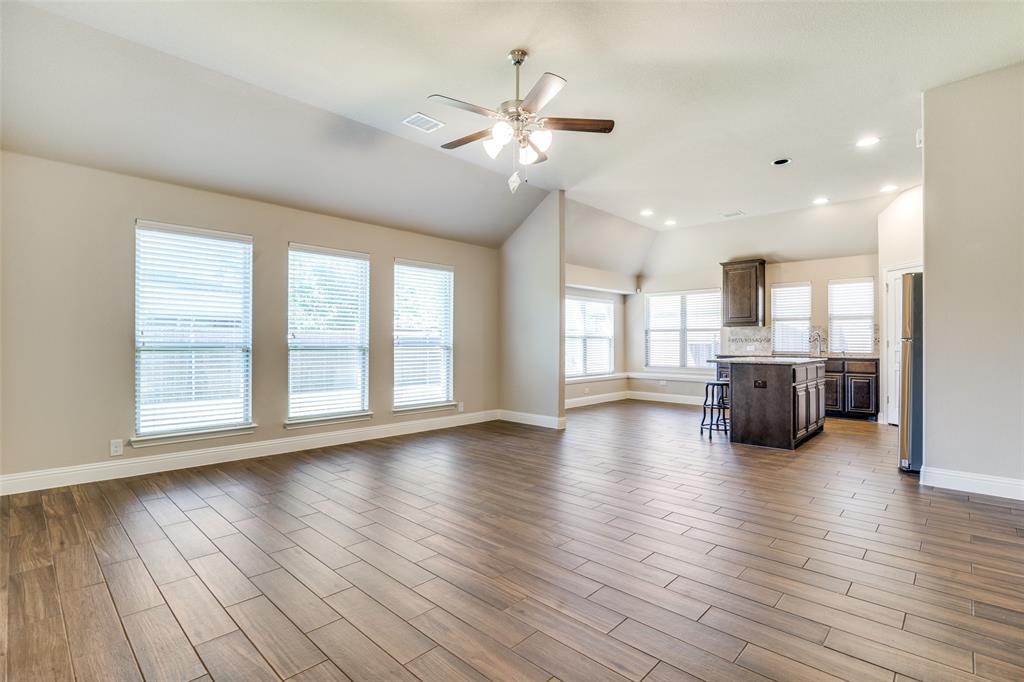 556 Avery Pointe Lavon, TX 75166 - Photo 7 of 32 a view of an empty room with wooden floor and a window