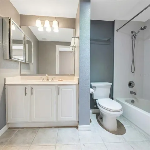 a white toilet sitting next to a bath tub and a shower