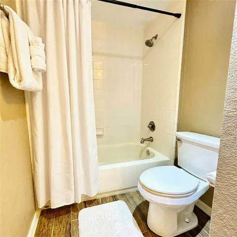 a view of a room with a window and wooden floor