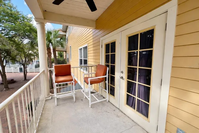 a outdoor space with patio lots of white furniture and large windows