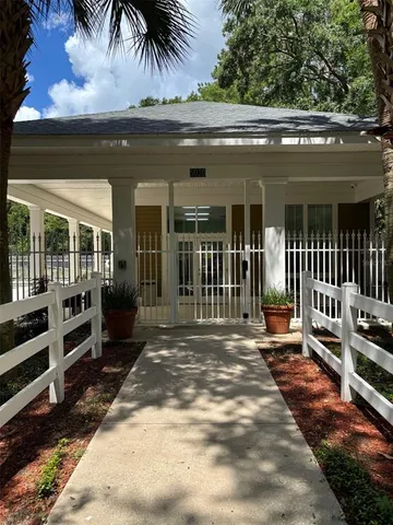 a view of a porch with chairs and backyard