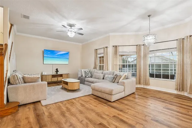 a living room with furniture and a chandelier
