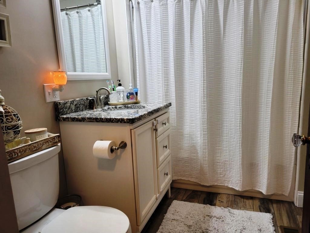 352 Chandler Street, Unit 1 Worcester, MA 01602 - Photo 11 of 23 a bathroom with a granite countertop sink and a mirror