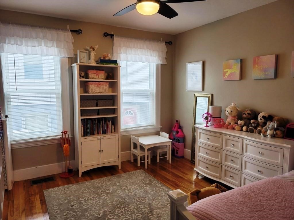 352 Chandler Street, Unit 1 Worcester, MA 01602 - Photo 19 of 23 a room with furniture a window and wooden floor