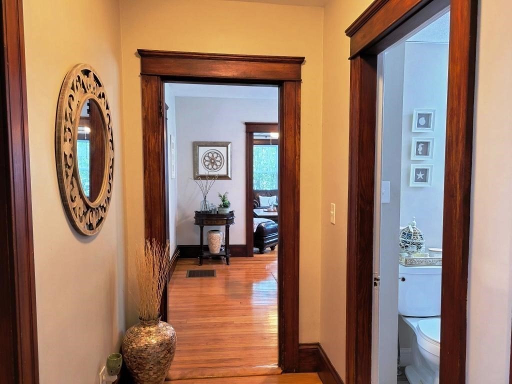 352 Chandler Street, Unit 1 Worcester, MA 01602 - Photo 8 of 23 a view of a hallway with wooden floor and a mirror