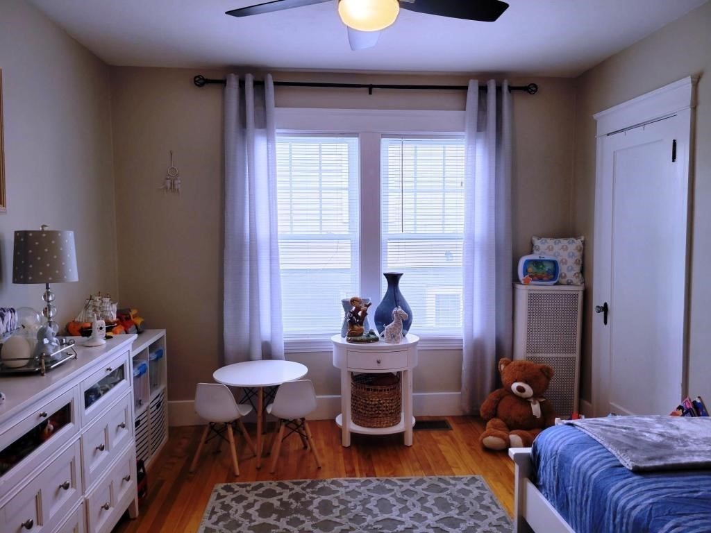 352 Chandler Street, Unit 1 Worcester, MA 01602 - Photo 10 of 23 a bedroom with a bed and a table in it