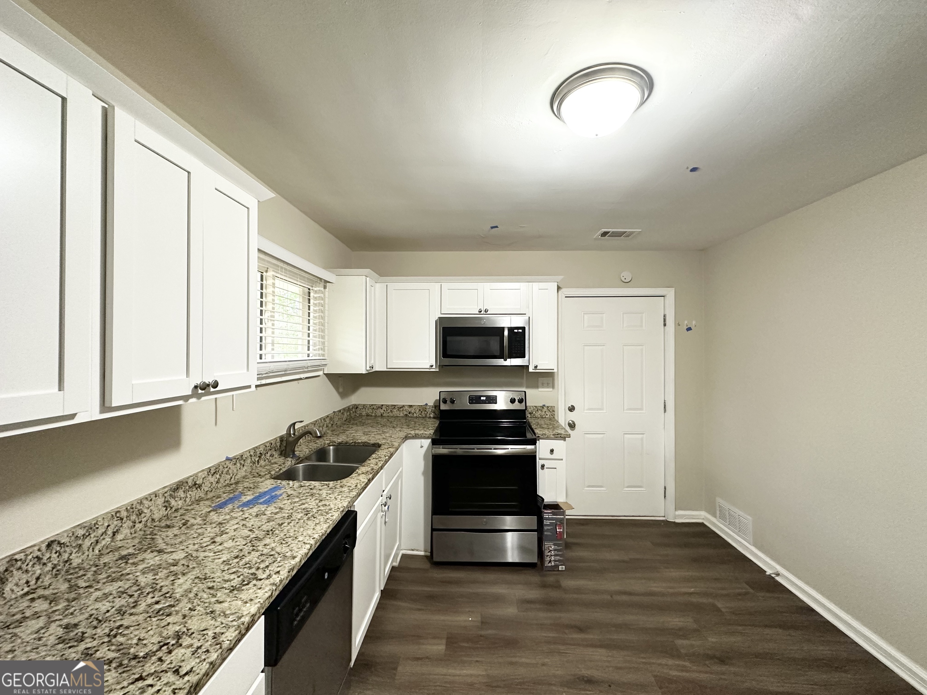 2310 Ousley Court Decatur, GA 30032 - Photo 6 of 11 a kitchen with stainless steel appliances granite countertop a stove and a sink