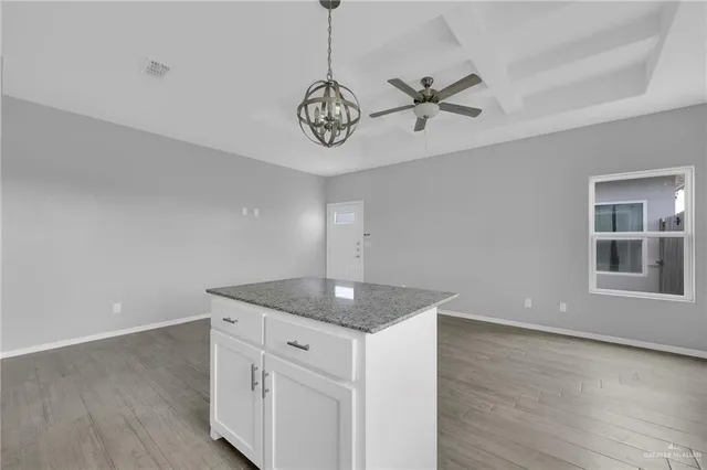 a kitchen with a counter space and wooden floor
