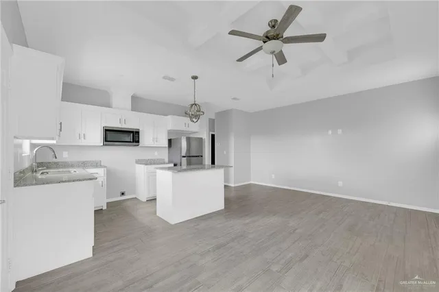 a view of kitchen with sink microwave and stove