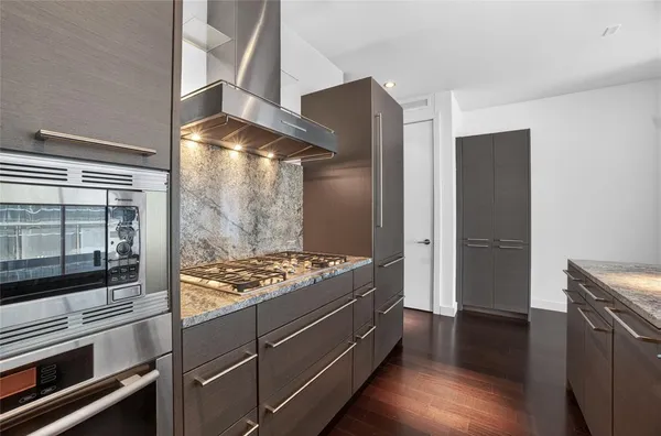 a kitchen with stainless steel appliances granite countertop a stove and a refrigerator
