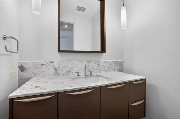 a bathroom with a sink a vanity and a mirror
