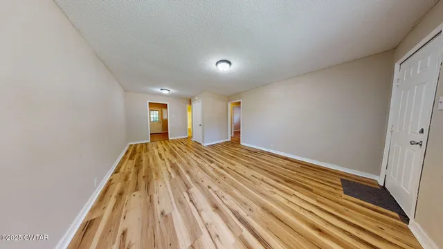 a view of a room with wooden floor