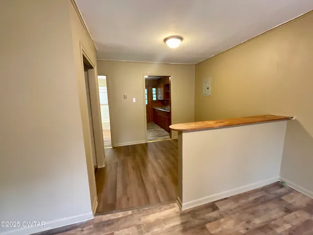 a view of hallway with wooden floor