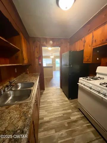 a kitchen with a stove and a refrigerator
