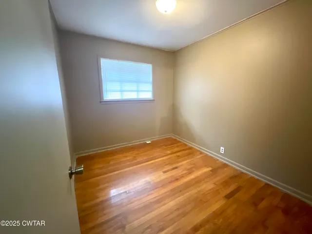 an empty room with a wooden floor