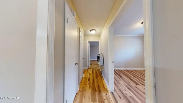 a view of hallway with wooden floor