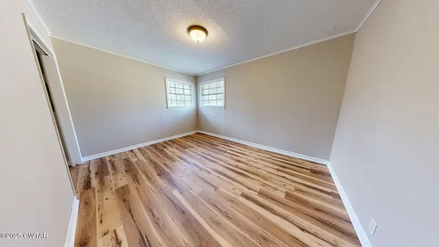 a view of a room with wooden floor and staircase