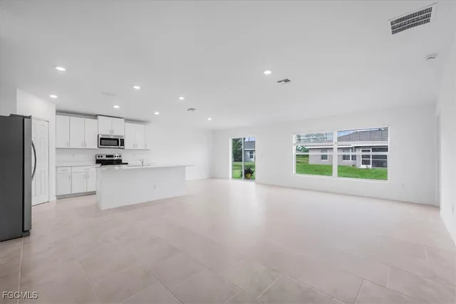 a kitchen with stainless steel appliances a refrigerator sink and microwave