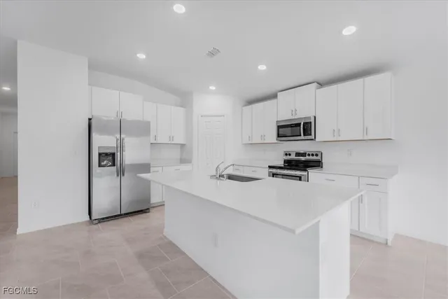 a kitchen with stainless steel appliances granite countertop a sink and a stove