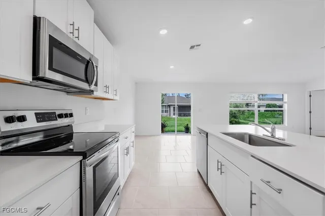 a kitchen with a sink and a refrigerator